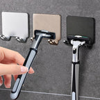 Porte-rasoir adhésif fixé au mur de douche